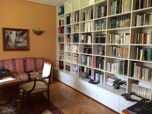 a room with a large book shelf filled with books at La Gaura Guest House in Casal Palocco