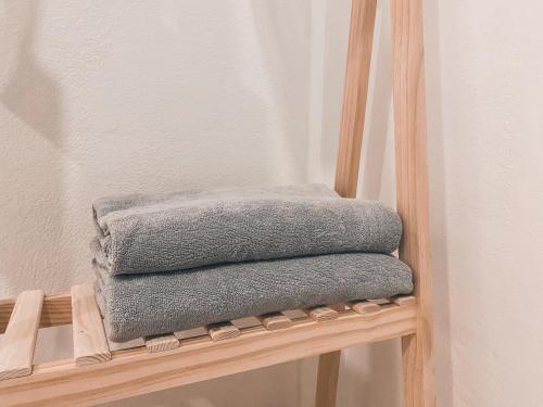 a stack of towels sitting on a wooden chair at Sundae Haus in Betong