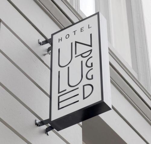 a sign on a building with a clock on it at Hotel Unplugged in Rotterdam
