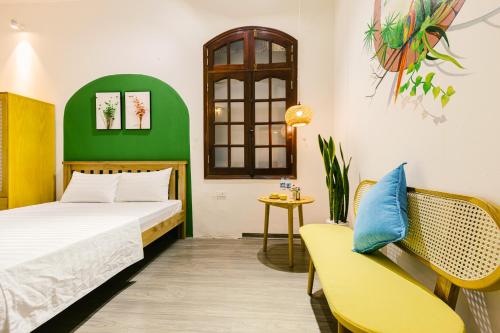 a bedroom with a bed and a chair at Eden Westlake Hotel in Hanoi