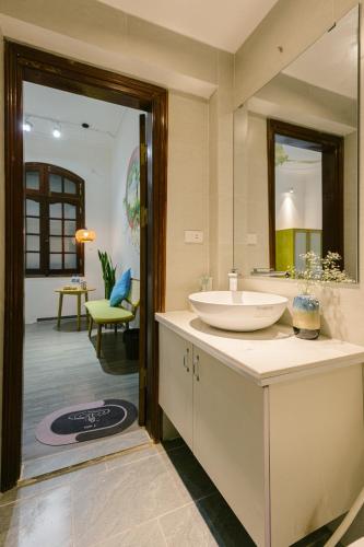 a bathroom with a sink and a mirror at Eden Westlake Hotel in Hanoi