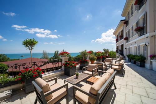 a patio with chairs and flowers on a balcony at Mula Hotel in Istanbul