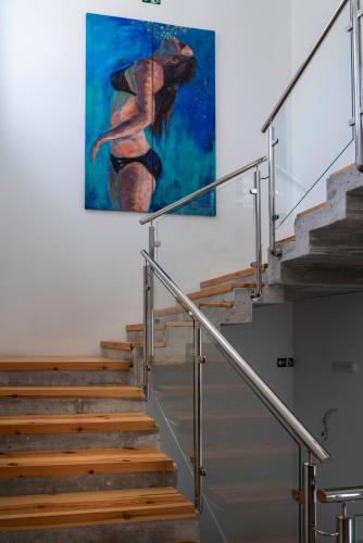 a painting of a woman on the wall at OPUNTIA Hotel Boutique in Mijas