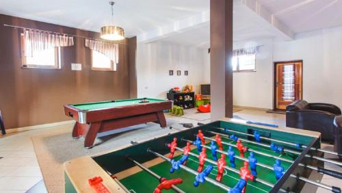 a living room with a pool table and a table at Chata u Bronka in Białka Tatrzanska