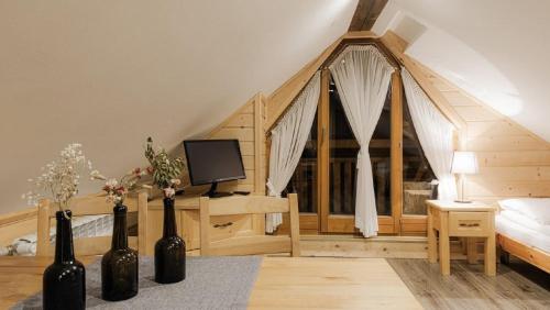 a bedroom with a bed and a tv in a room at Chata u Bronka in Białka Tatrzańska