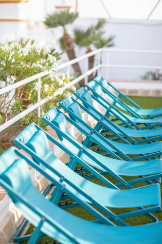 a pair of blue chairs sitting on a balcony at Soho Boutique Puerto in El Puerto de Santa María