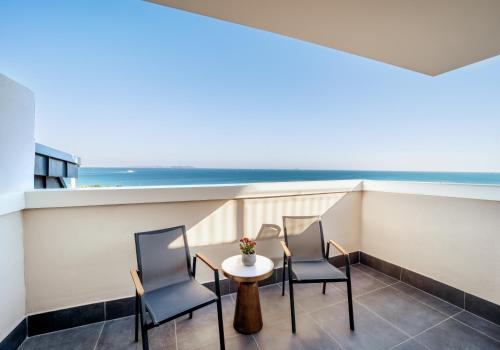 a balcony with chairs and a table and a view of the ocean at Mula Hotel in Istanbul