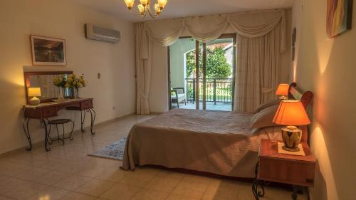 a bedroom with a bed and a desk and a window at dolphine apatment turunç in Marmaris