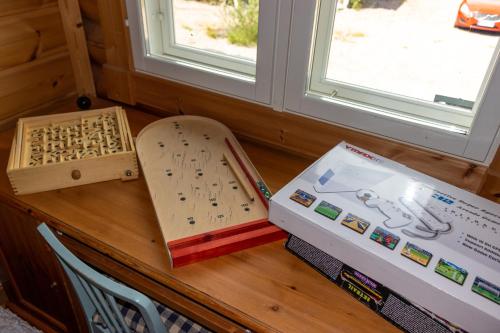 a table with a book and a box next to a window at Luxury Villa Rahavaara in Joensuu
