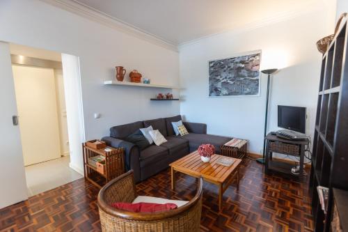 a living room with a couch and a table at Sun & Beach Apartment by Soulplaces in Costa da Caparica