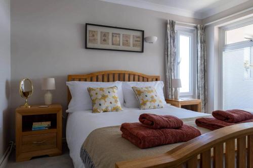 a bedroom with a bed with two towels on it at Needles Point in Milford on Sea