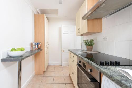 a kitchen with a counter with a bowl of fruit on it at Rosebud in Portreath