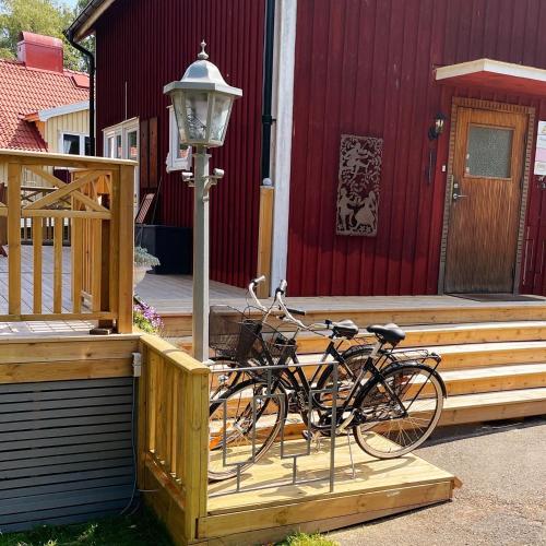 a bike parked on a porch next to a building at Photoeverhome in Bengtsfors