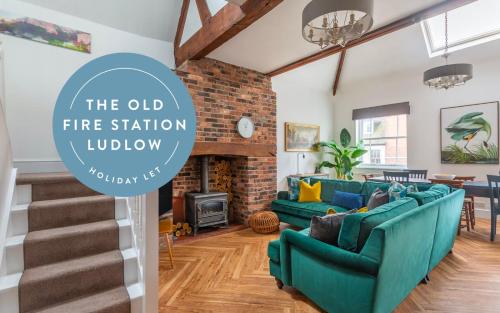 an old fire station lobby with blue couches and a living room at The Old Fire Station Ludlow in Ludlow