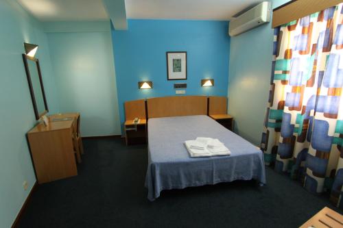 A bed or beds in a room at Hotel São Lourenço