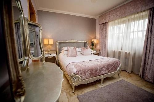 a bedroom with a bed and a large mirror at Mulberry House in Swansea