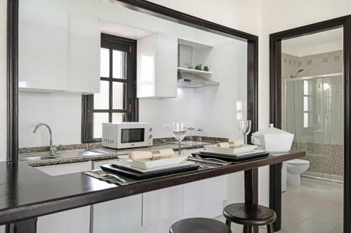 a kitchen with a counter with a microwave and a sink at Casa Marina 14 in Puerto del Carmen