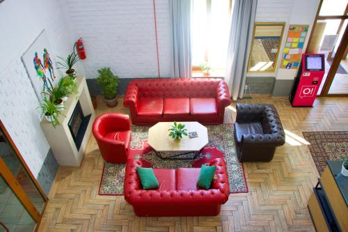 a living room with red couches and a coffee table at ololoFreelander Hostel&Coworking in Bishkek