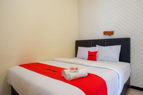a bedroom with a bed with two towels on it at RedDoorz At Hotel Sartika Yogyakarta in Yogyakarta