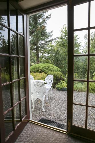 an open door with a table and chairs outside at Killeena House in Baltimore