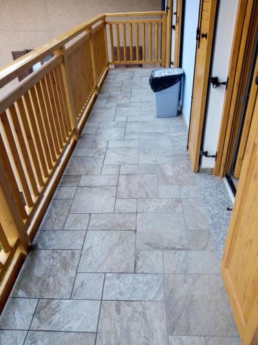 a hallway with a tile floor in a house at Appartamenti Sasso Rosso in Commezzadura