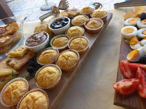 a tray of muffins and other food on a table at Guest House Vera in Ulcinj