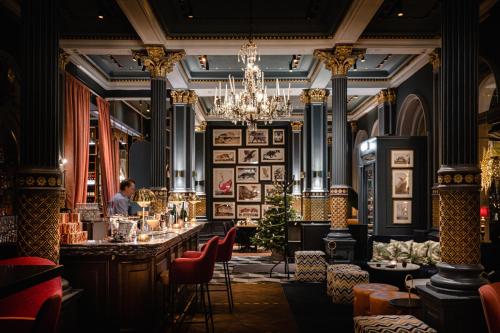 a restaurant with a bar with a person in the background at Elite Hotel Mollberg in Helsingborg