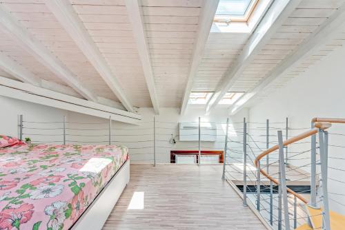 a bedroom with a bed and a staircase at Honey Loft [Milano-Como-Svizzera] in Seregno