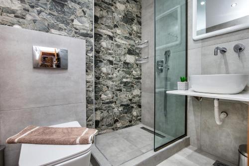 a bathroom with a sink and a glass shower at Kalogeraki Studios in Potos