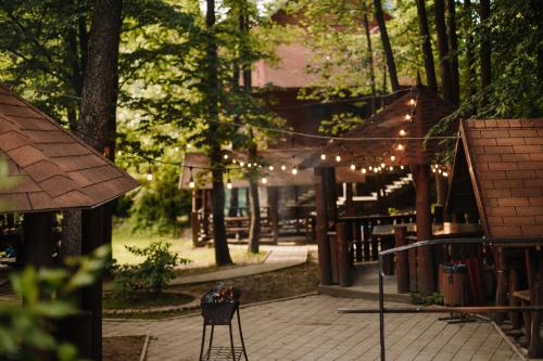 a patio with string lights and a table and chairs at Voevodyno Resort in Tur'ya Pasika