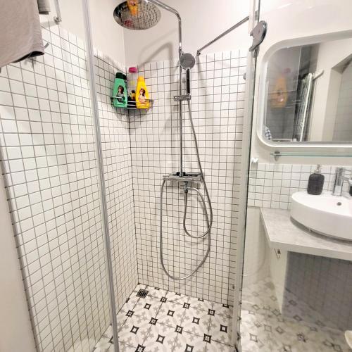 a shower stall in a bathroom with a sink at HaPPy Inn Laime Studio, Self Check-In-24-7, A-C, Parking-in-the-underground-Garage in Vilnius