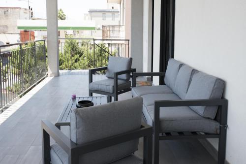 two chairs and a couch on a balcony at AA Residence - free private parking in Sarno