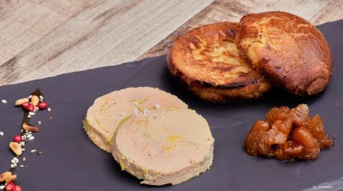 a plate of food with bread and nuts on a table at Logis Hotel, restaurant et spa Le Relais De Broceliande in Paimpont