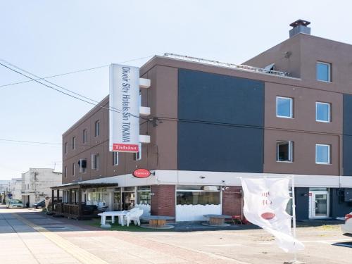 a building with a sign on the side of it at Tabist Diversity Hotel Sin Tokiwa Asahikawa in Asahikawa