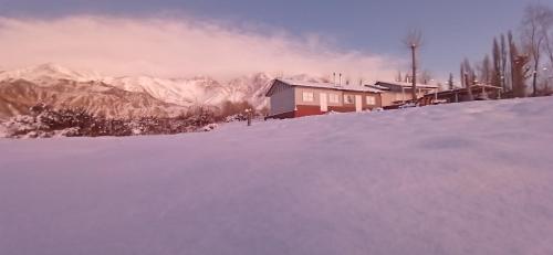 a house on top of a snow covered mountain at Cabañas Nubes del Plata in Potrerillos