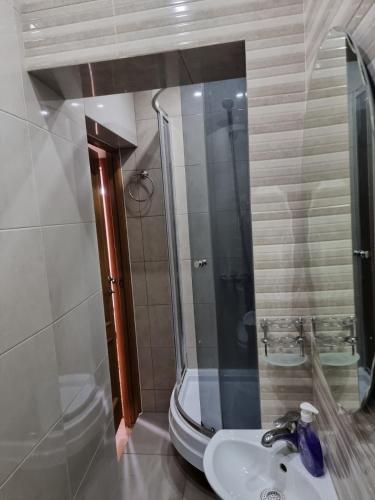 a bathroom with a sink and a shower at Apartament centru in Chişinău