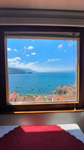 a view of the ocean from a bedroom window at Villa Malezan in Ohrid