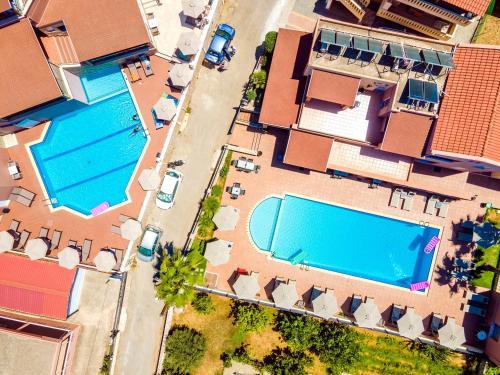 an overhead view of a house with two swimming pools at Theos Holidays Apartments in Kato Daratso
