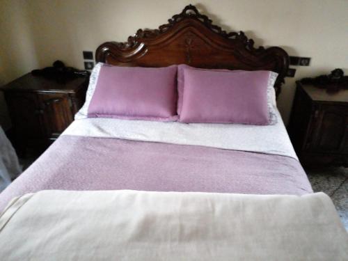 a bed with purple and white sheets and pillows at Maison vintage Rabat Agdal in Rabat