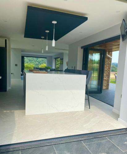 a kitchen with a white counter in a room at Stunning modern home set in beautiful grounds. in Bath