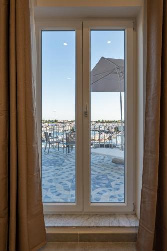 a sliding glass door with a view of a patio at Baia Flegrea Meublè in Bacoli