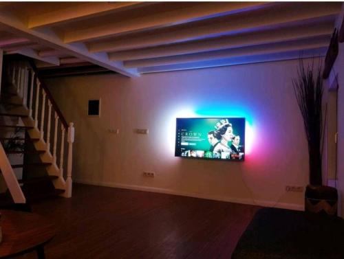 a living room with a tv on a wall at Beautiful Duplex in the center of Brussels in Brussels