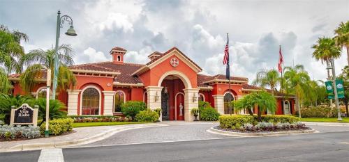 a large orange building with palm trees and a street at Baywatch in Clearwater