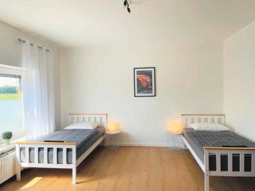 Ένα ή περισσότερα κρεβάτια σε δωμάτιο στο Moderne Apartments Bedburg-Hau