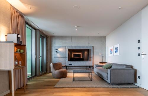 a living room with a couch and a fireplace at b'mine Hotel Frankfurt Airport in Frankfurt/Main