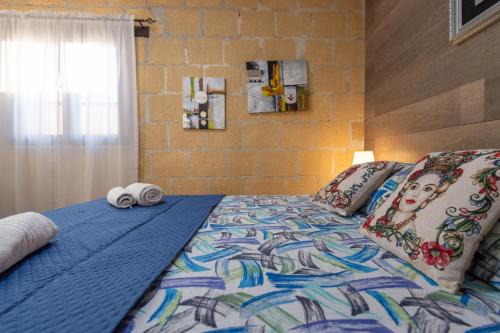 a bed with two towels on top of it at Villa Ina in Cinisi