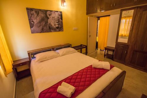 a bedroom with a large bed with a red blanket at Cheerful 2-bedroom near Auro Beach in Kālapettai