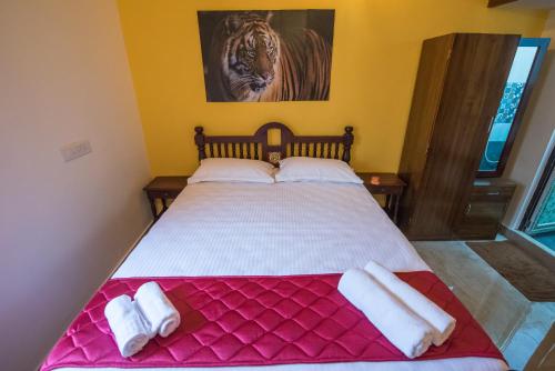 a bedroom with a large bed with towels on it at Cheerful 2-bedroom near Auro Beach in Kālapettai