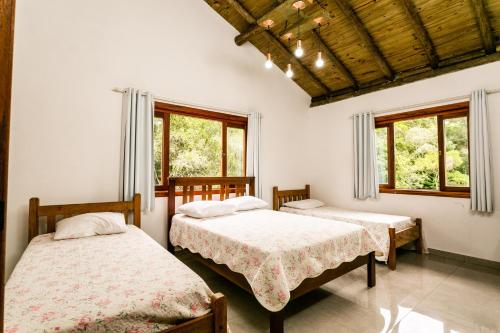 Giường trong phòng chung tại Recanto Namastê - Hospedagem