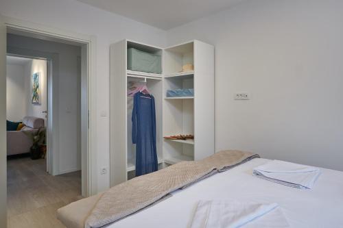 a bedroom with a bed and a closet at Villa Nika with private heated pool in Slano